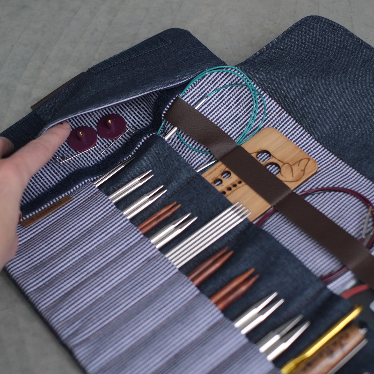 Poche latérale secrète de l'étui d'aiguilles denim bleu foncé ouverte — rangement petits accessoires tricot et crochet, Jésabelle B. | Hidden side pocket of dark denim needle case open — storage for small knitting and crochet accessories, Jésabelle B.
