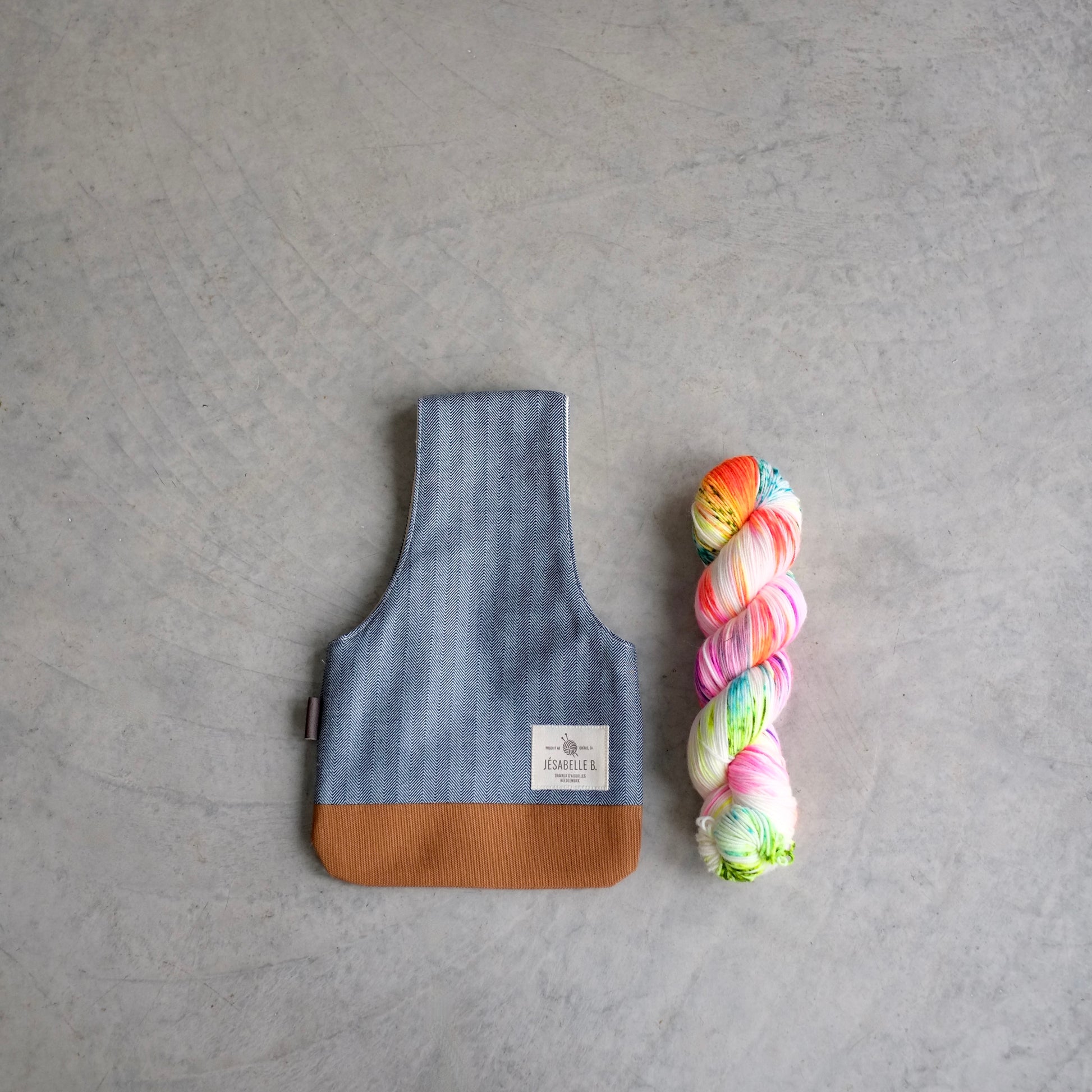 Top view of knitting bag next to yarn skein to show size / Vue de haut d'un sac de tricot petit à côté d'un écheveaux de laine pour montrer le format